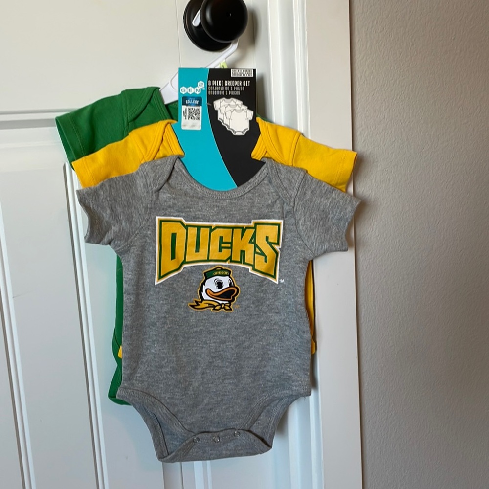 Set of Oregon Duck onesies.
